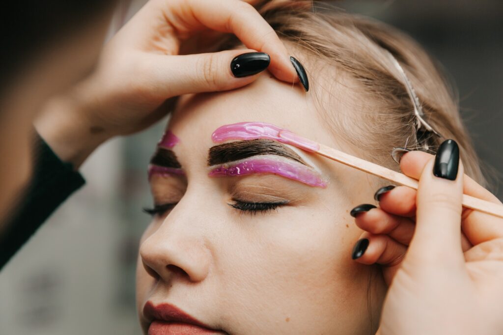 girl hairstyle near eyebrows waxed in beauty salon. and microblading eyebrow tint.